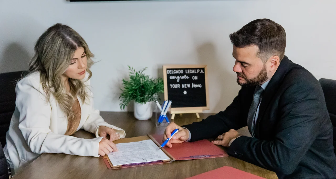 Attorney consulting with client at Delgado Legal P.A.